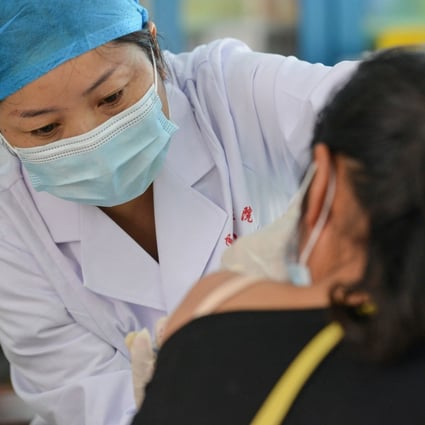 A woman in Anhui province receives a coronavirus vaccine in May. Photo: STR/AFP