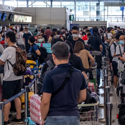 People pack the check-in area for their flight to Britain at Hong Kong’s International Airport on July 18, 2021. Photo: AFP