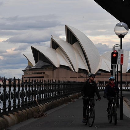 A mostly quiet walkway under the Sydney Harbour Bridge amid a lockdown as cases surge in the state. Photo: AFP