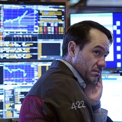 A trader works in a booth on the floor of the New York Stock Exchange, July 19, 2021. Photo: AP