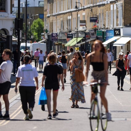 People in Broadway Market in Hackney, London. England has lifted most of its coronavirus rules. Photo: Bloomberg