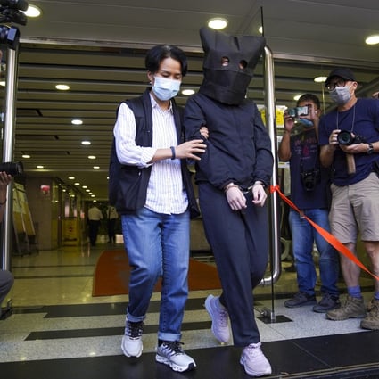 One of the five suspects arrested under the national security law on Thursday is walked out of Hung Hom Commercial Centre by police. Photo: Sam Tsang