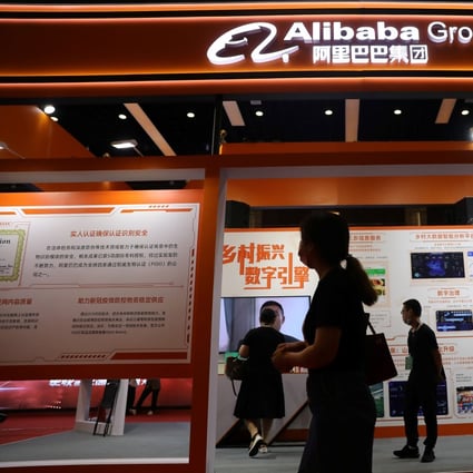 People walk past a booth of Alibaba Group at an exhibition during the China Internet Conference in Beijing, China on July 13, 2021. Photo: SCMP