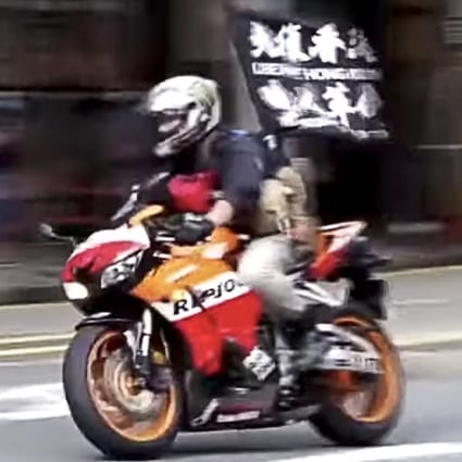 Leon Tong Ying-kit, who faces a sentence of up to life imprisonment, rode a motorcycle through police check lines in Wan Chai during protests on July 1 last year, a day after the passing of the security law. The motorcycle displayed a flag with the slogan, “Liberate Hong Kong; revolution of our times”. Photo: Cable TV