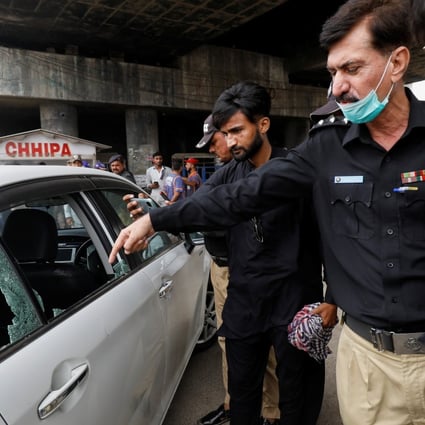 A police officer surveys the site after gunmen on a motorcycle opened fire on a vehicle belonging to a Chinese national in Karachi, Pakistan on Wednesday. Photo: Reuters