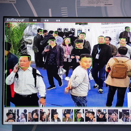 A screen shows visitors being filmed by AI security cameras with facial recognition technology at the 14th China International Exhibition on Public Safety and Security at the China International Exhibition Center in Beijing on October 24, 2018. Photo: AFP