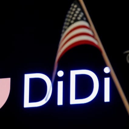 An American flag is seen in front of the logo for Chinese ride hailing company Didi during the initial public offering on the New York Stock Exchange floor in June. Photo: Reuters