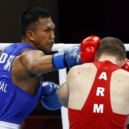 Eumir Marcial of the Philippines lands a punch on Arman Darchinyan of Armenia during their quarter-final contest at the Tokyo Olympics on Sunday. Photo: EPA-EFE