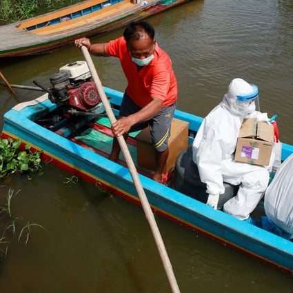 Health workers travel by boat to bring Covid-19 swab tests to rural residents near Bangkok. Photo: Reuters