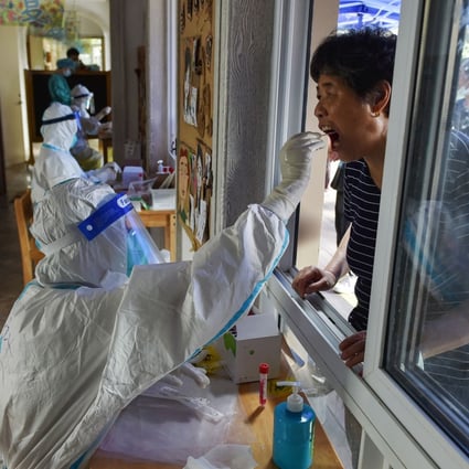 A resident gets tested in Nanjing on Monday as the country grapples with its most widespread outbreak in months. Photo: AFP
