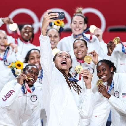 Team USA pose for a photo after beating hosts Japan to win the women’s basketball gold medal at the Tokyo Olympics on Sunday. Photo: Xinhua