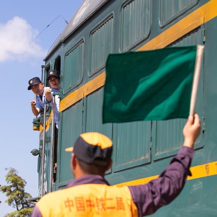 A trainee in Laos learns train signals from a Chinese mentor on the northern outskirts of Vientiane ahead of the opening of the China-Laos railway. Photo: Xinhua