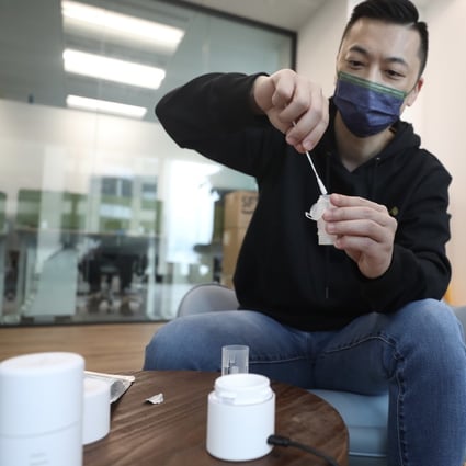 Danny Yeung Sheng-wu, chief executive officer and co-founder of Prenetics Group, demonstrating how a specimen capsule with a nasal swab is placed into a Circle HealthPod for a Covid-19 test, on August 6, 2021. Photo: Xiaomei Chen