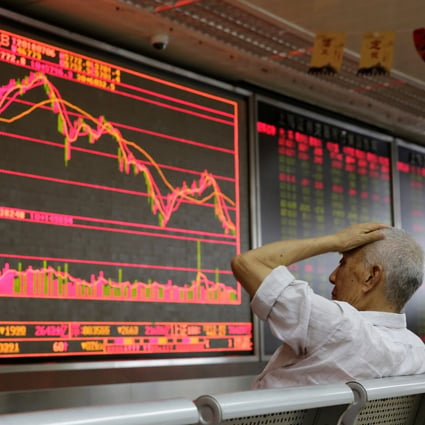 An investor looks at a board showing stock information at a brokerage in Beijing. Photo: Reuters