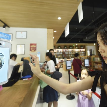 A female customer has her face scanned by a face recognition system added with beauty filters supported by face recognition technology of Alipay. Photo: Imaginechina