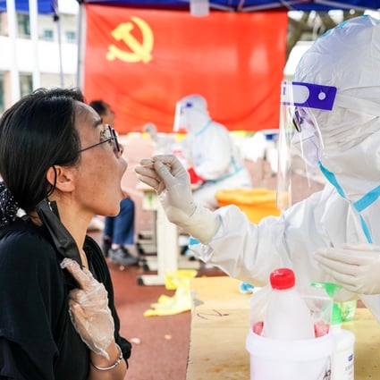 A medical worker tests a woman for Covid-19 in the city of Yangzhou, which conducted its latest round of mass testing on Monday. Photo: Xinhua