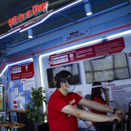 Staff demonstrate a VR cycling system during a media tour of SmarTone 5G Lab at Sky 100 at the International Commerce Centre in Hong Kong on May 1. Telecoms companies are betting on virtual and augmented reality to help recoup the costs of building 5G networks. Photo: SCMP/Sam Tsang