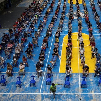 People wait to get vaccinated against Covid-19 in Manila, Philippines. Photo: Reuters