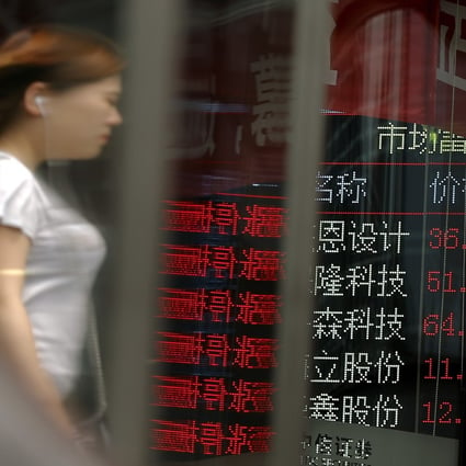 A woman is reflected on a glass panel as she walks by a brokerage house displaying stock trading index in Beijing. Photo: AP