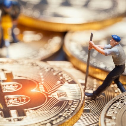 Concept photo of figurines of miners on a stack of bitcoin. Photo: Shutterstock