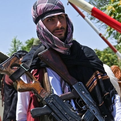 Taliban fighters stand guard along a road near Zanbaq Square in Kabul on Monday. Photo: TNS