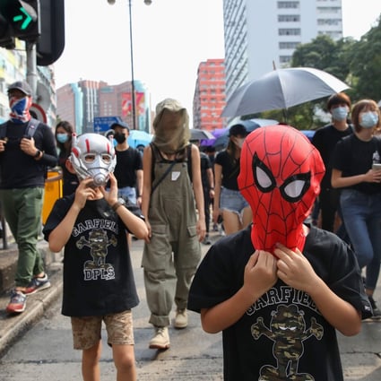 Two children wearing superhero masks take part in a march in Jordan on October 20, 2019. Photo: Winson Wong