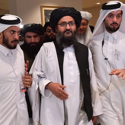 Taliban co-founder Mullah Abdul Ghani Baradar (centre), tipped to become Afghanistan’s next president, pictured in Qatar after signing the 2020 peace agreement with the US which paved the way for the group’s resurgence. Photo: AFP
