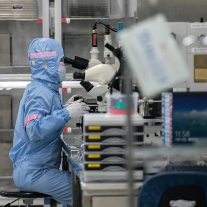 A worker is seen inside the production area at chipmaker Renesas Electronics in Beijing on May 14, 2020. Photo: AFP
