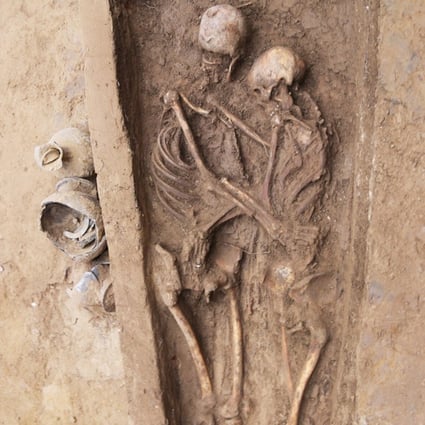 Two skeletons unearthed in north China appear to be in a lover’s embrace. Researchers found a band on the woman’s ring finger. Photo: Xinhua