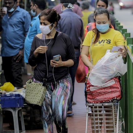 Shoppers at a market in Little India. Photo: EPA-EFE