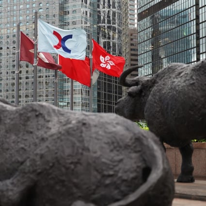 Bronze sculptures of bulls, the symbol of the Hong Kong Stock Exchange and the flag of HKEX flying next to the Hong Kong SAR flag, at the Exchange Square in Central on 2 June 2020. Photo: Winson Wong