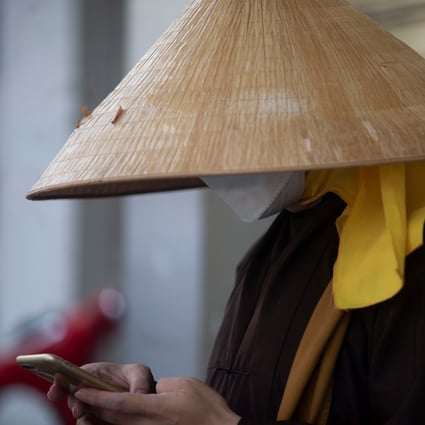 A monk uses his mobile phone in Ho Chi Minh City. A survey found Vietnamese are wary of China’s growing strategic clout and supportive of US influence in the region. Photo: Reuters