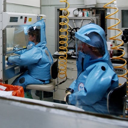 Work in progress at the US Army Medical Research Institute of Infectious Diseases at Fort Detrick, Maryland, in 2002. Research at the facility, equipped to handle dangerous pathogens such as Ebola and plague, was suspended in 2019 over safety concerns. Photo: AFP