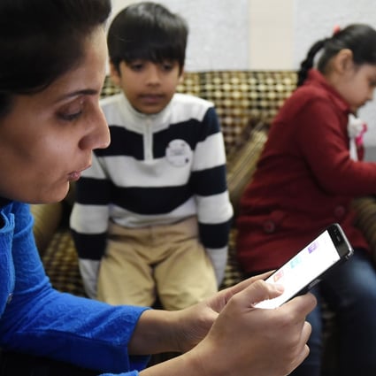 An Indian teacher uses an app that uses ‘gamified’ methods to help children learn. Photo: AFP