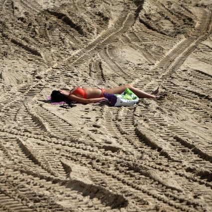 A woman sunbathes on the beach in Cannes, France. File photo: AP