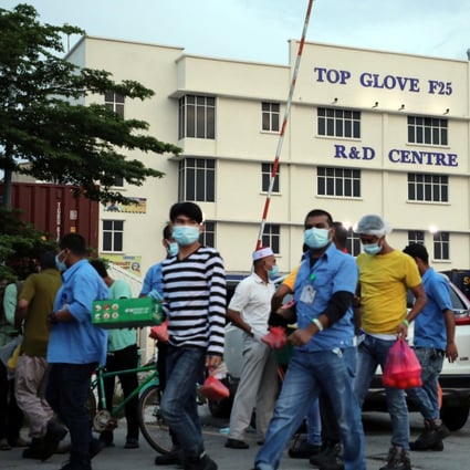 Workers leave a Top Glove factory after their shifts in Klang, Malaysia. Photo: Reuters