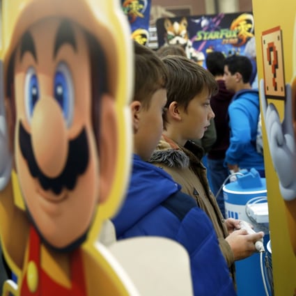 Mario, a character from Nintendo’s Mario franchise, next to young players at the Legends of Gaming Live event in London on 15 September 2015. Photo: Bloomberg
