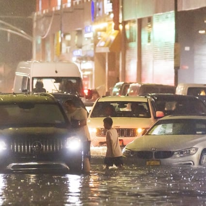 Cars stuck on a street flooded by heavy rain in the Queens borough of New York. Photo: EPA