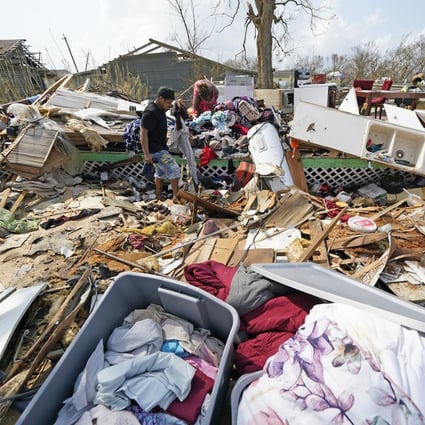 A man helps his mother sift through what remains of her home in the aftermath of Hurricane Ida in Golden Meadow, Louisiana. Photo: AP