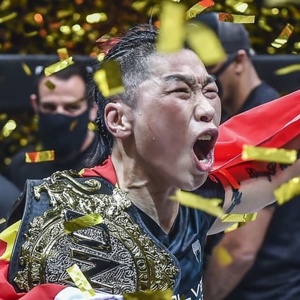 Xiong Jingnan celebrates with her ONE strawweight title after beating Michelle Nicolini. Photos: ONE Championship