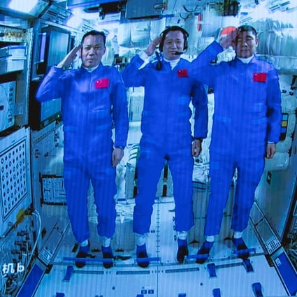 Three Chinese astronauts onboard the Shenzhou-12 spaceship saluting after entering the Tianhe space station core module in June. Photo: EPA-EFE/Xinhua/Jin Liwang