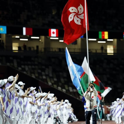 Badminton player Chu Man-kai of Hong Kong carries the flag during the closing ceremony of the Tokyo 2020 Paralympic Games. Photo: Reuters
