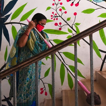 A worker cleans a stairway at a government school. Photo: EPA-EFE