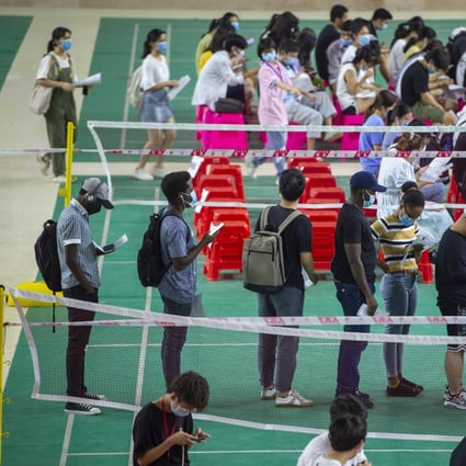 Foreign students queue up to receive Covid-19 vaccines at Hainan Medical University on June 8, 2021. Photo: Getty