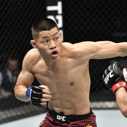 Li Jingliang punches Santiago Ponzinibbio in their welterweight UFC bout. Photo: Jeff Bottari/Zuffa LLC