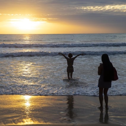 Tourists pictured on a near-empty beach in Phuket, Thailand, in July. Photo: Bloomberg