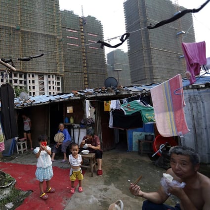 A poor migrant family eats dinner at their makeshift shelter next to a construction site in China’s Zhejiang province, where authorities in July launched a pilot programme designed to achieve common prosperity by 2025. Photo: Reuters