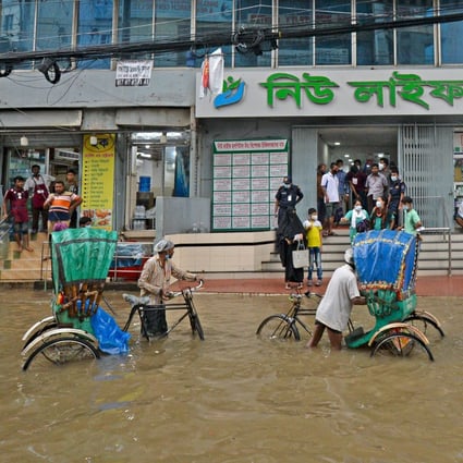 A waterlogged street in Dhaka in July. Bangladesh is particularly affected by flooding and crop failures, accounting for almost half of a World Bank report’s predicted climate migrants. Photo: AFP