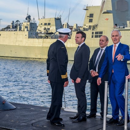 French President Emmanuel Macron (second left) and former Australian prime minister Malcolm Turnbull (second right) stand on the deck of a submarine operated by the Australian navy in Sydney. File photo: AFP