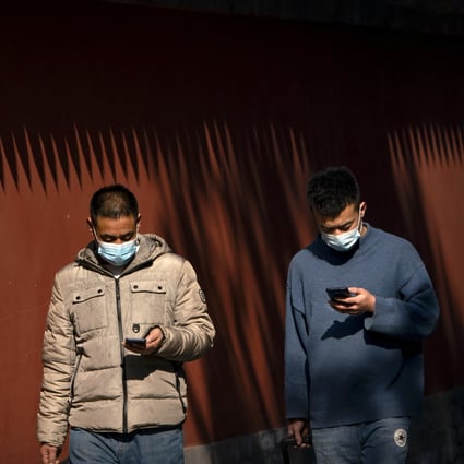 People use their smartphones as they walk through Ditan Park in Beijing on February 9. China’s new guidelines for building a “cyberspace civilisation” are just the latest move from the Chinese government seeking to exert more control over online narratives. Photo: AP